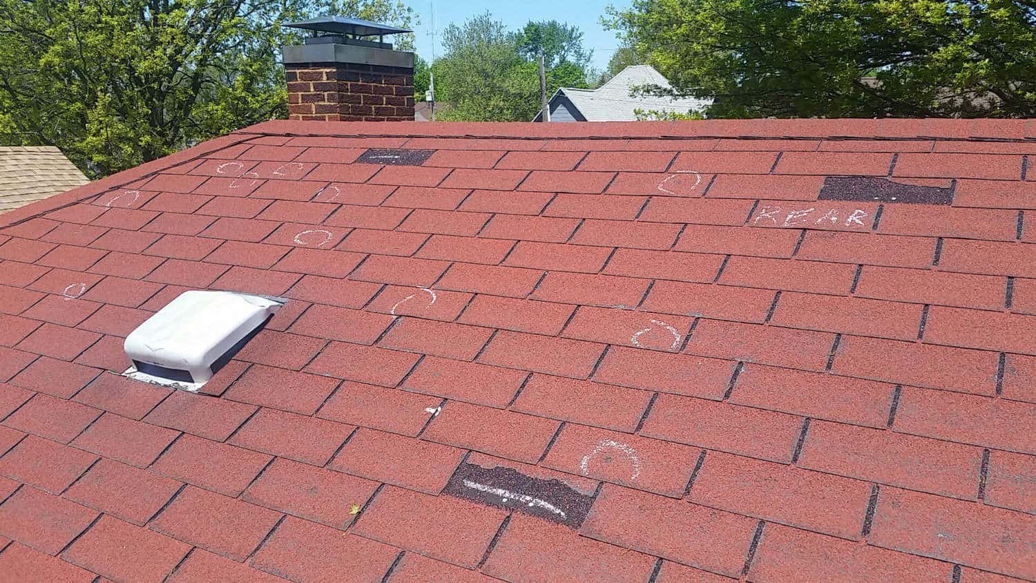 Hail Damage On A Red Asphalt Roof