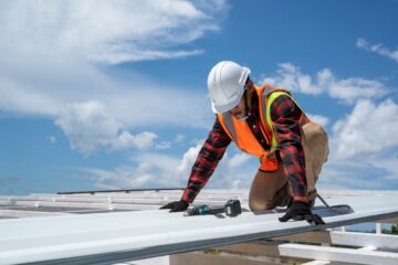 man working on metal roof